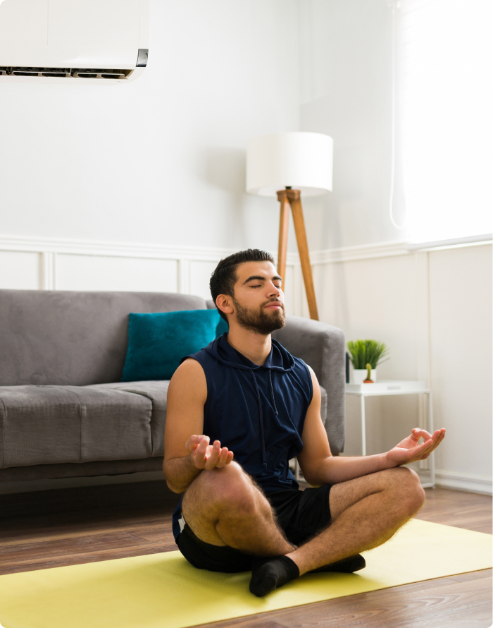 Man doing yoga on a yellow mat