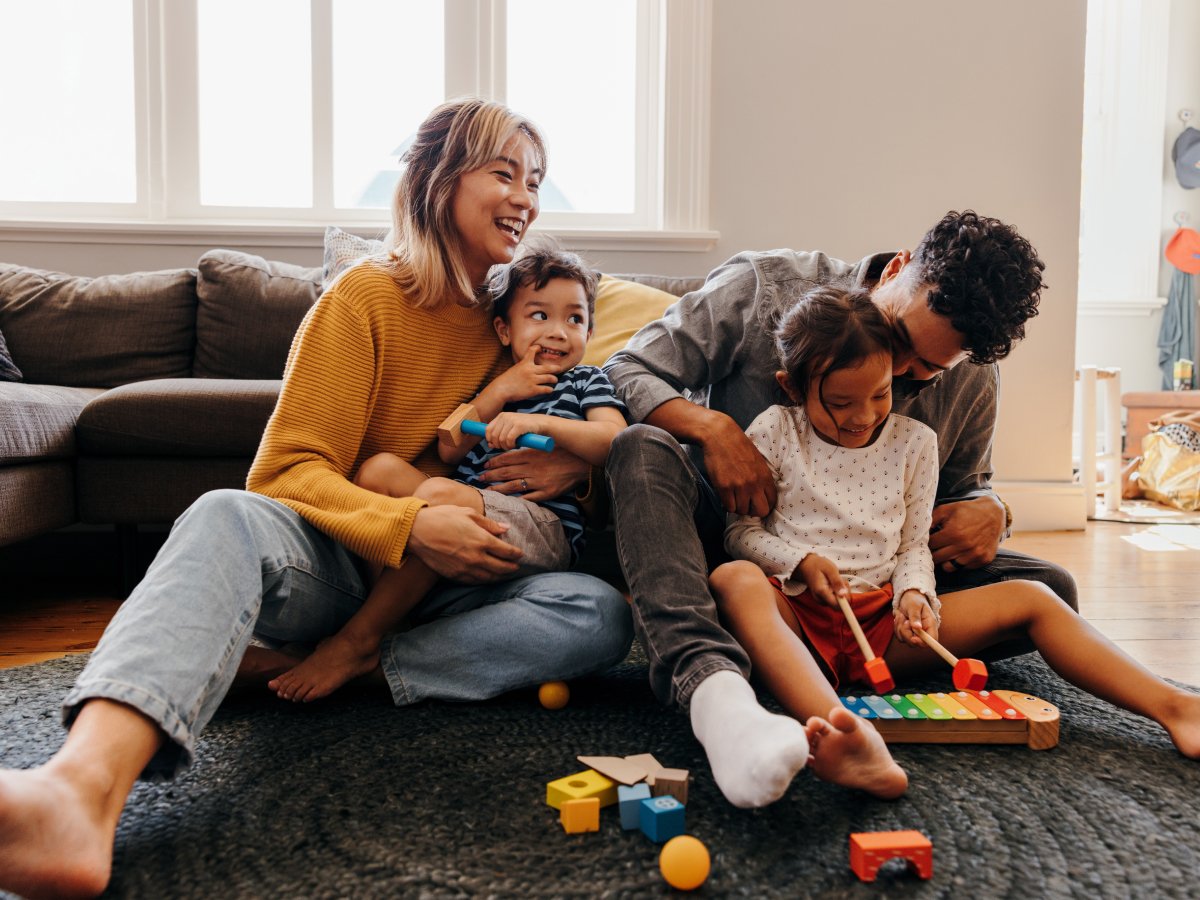 Family playing with child's toys