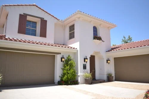 Garage doors flanking home entrance