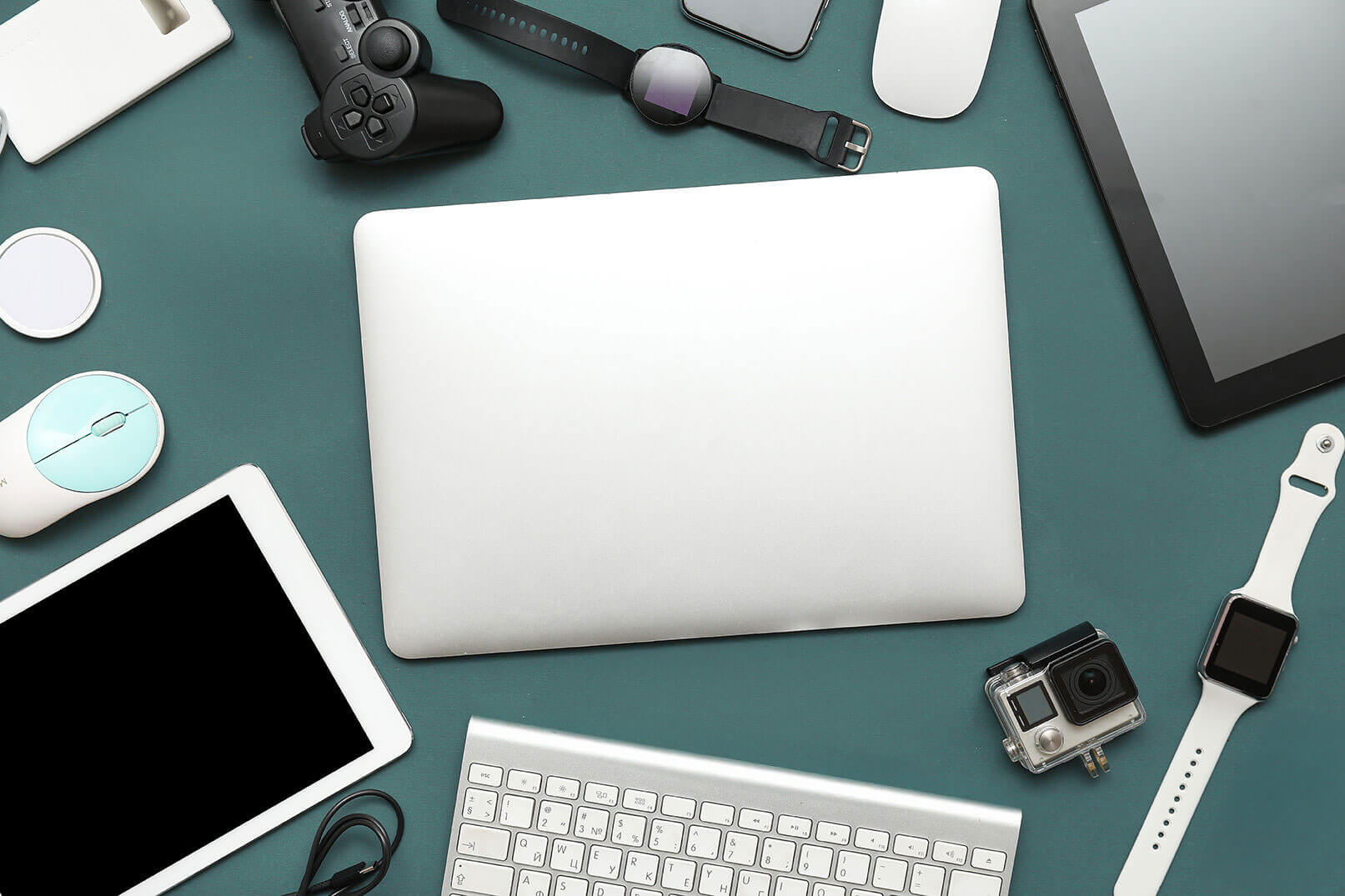 Various electronic devices on a blue table