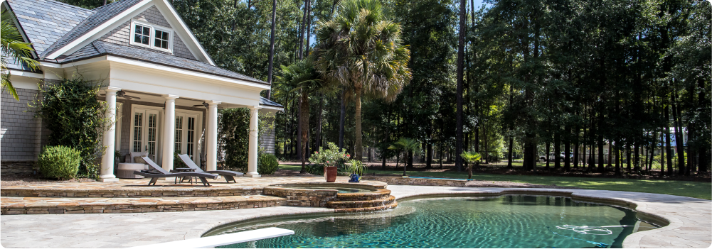 Backyard of a home with a pool, trees and sunny day