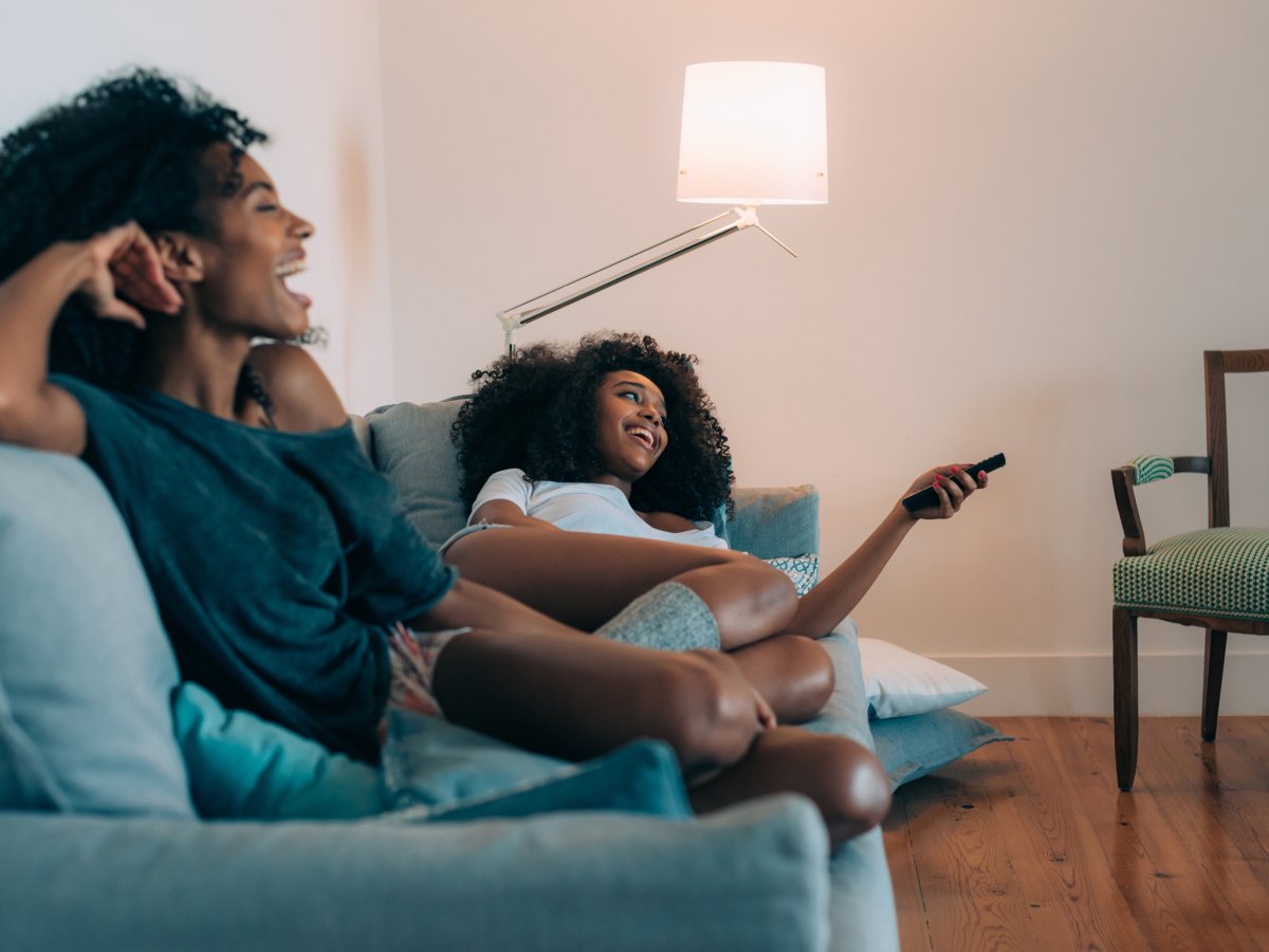 AHS Customers smiling watching TV on a couch