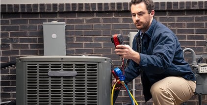 Pro inspecting outdoor appliance