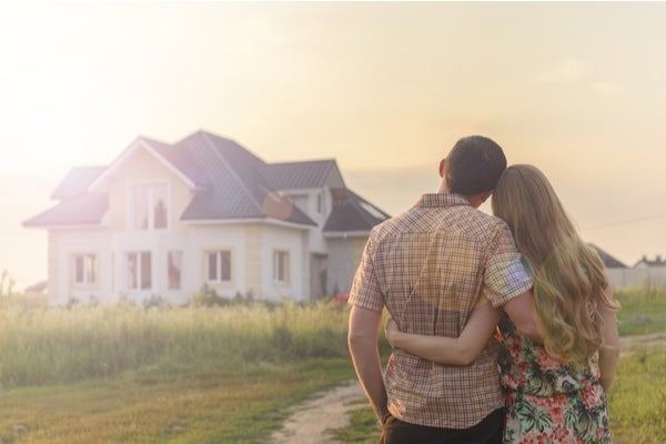 Couple outside of their home