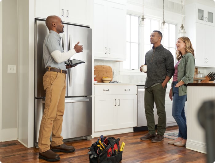 couple speaking to repair pro