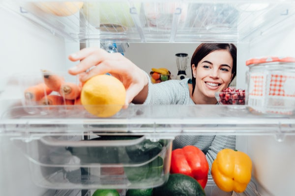 reaching into refrigerator