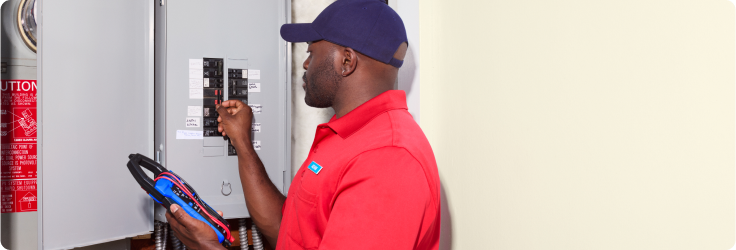 technician inspecting breaker box