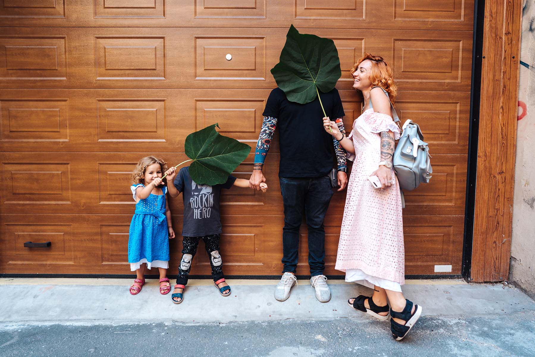 A family standing outside of a garage door