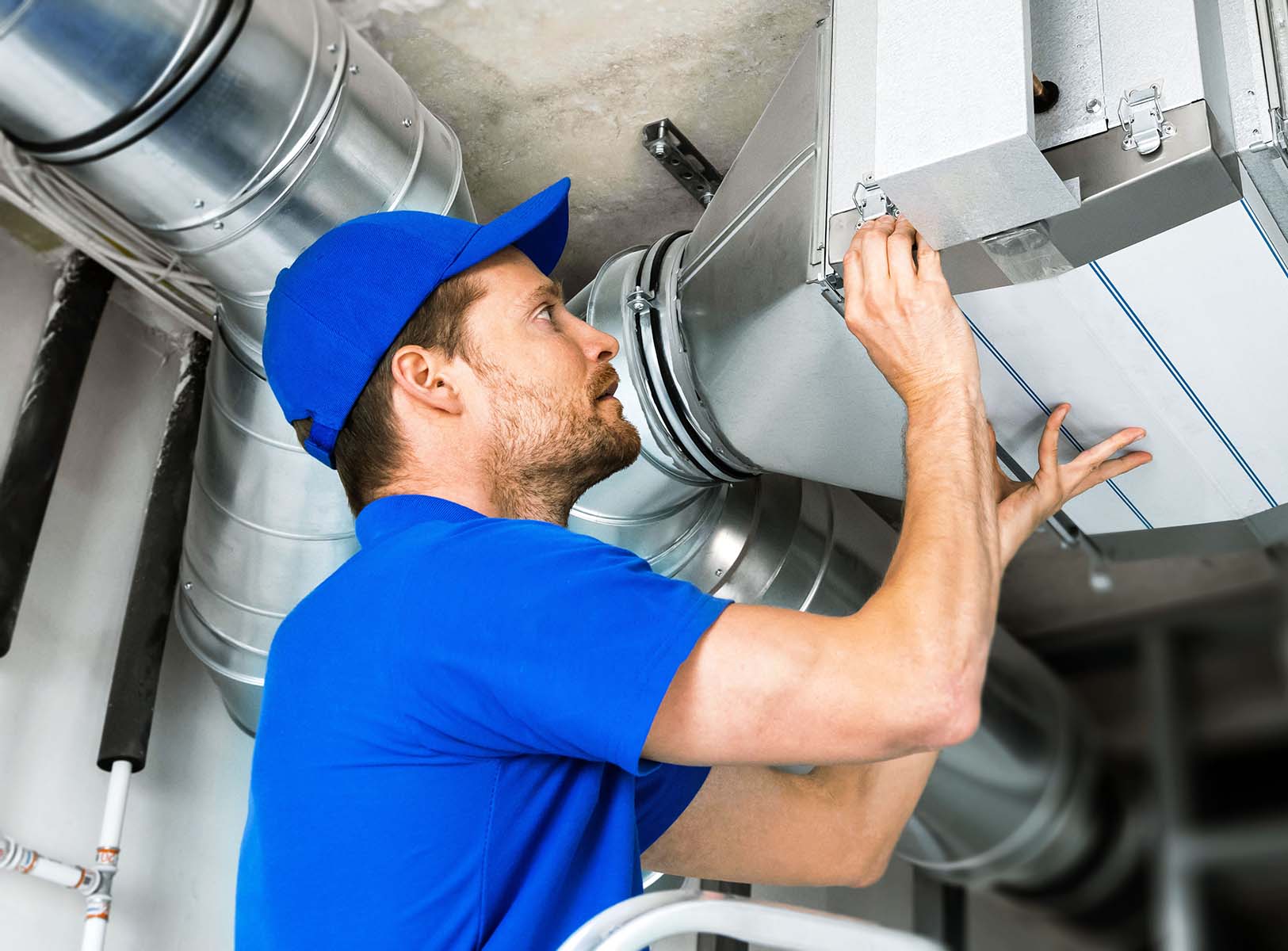 Technician working on industrial air ducts.