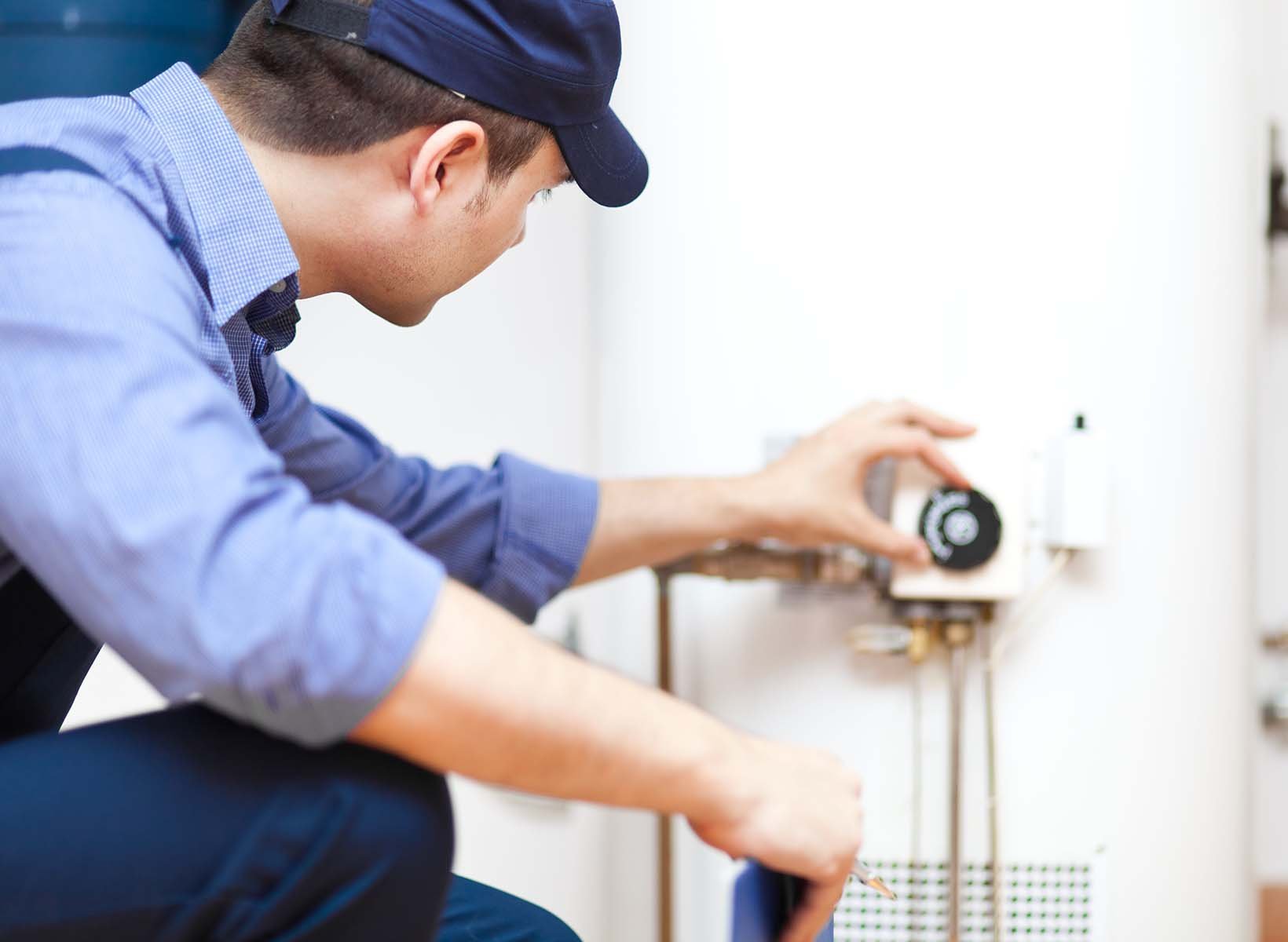 man adjusting water heater