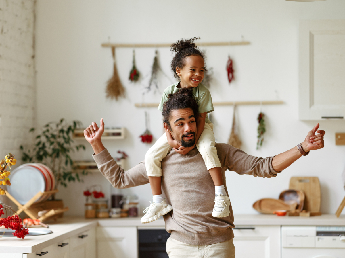 Dad giving piggyback ride to child