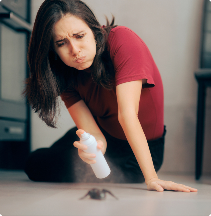 Woman spraying bug with solution