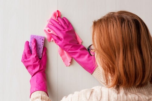 woman cleaning a wall