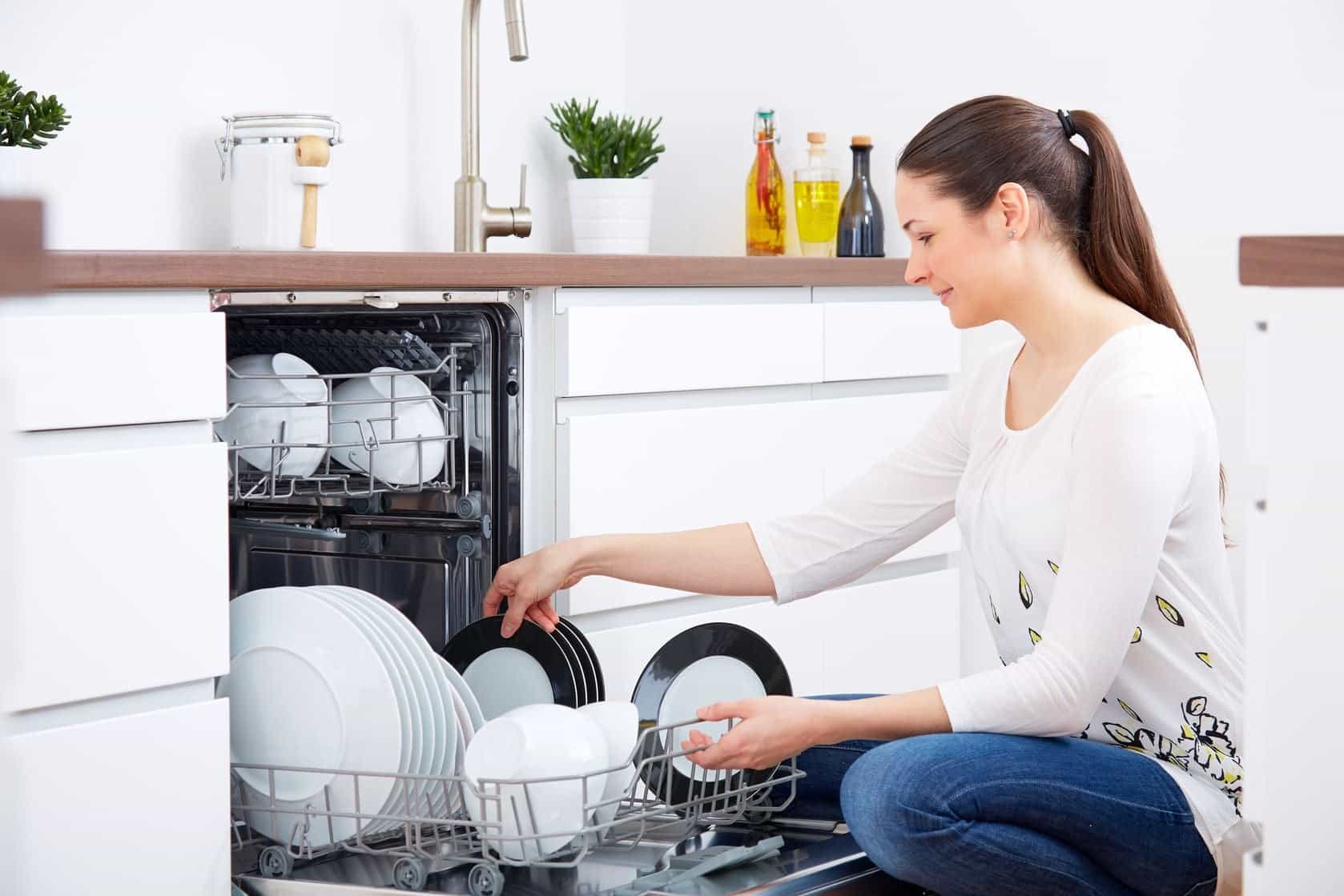 woman loading dishwasher