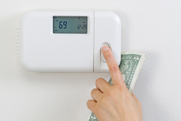 setting thermostat with money in hand