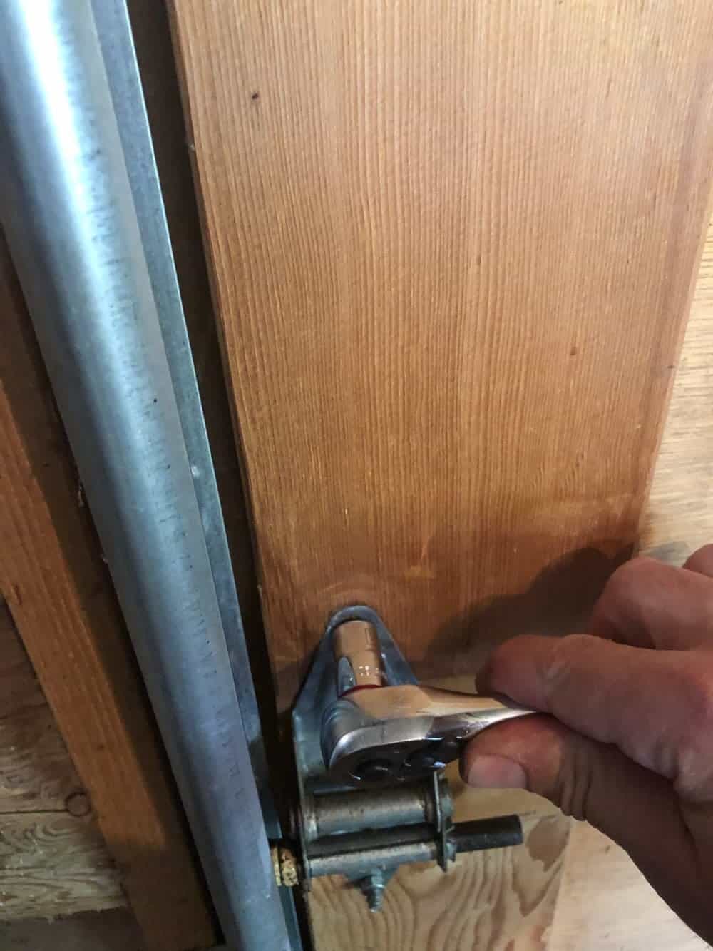 tightening garage door hinge bolt